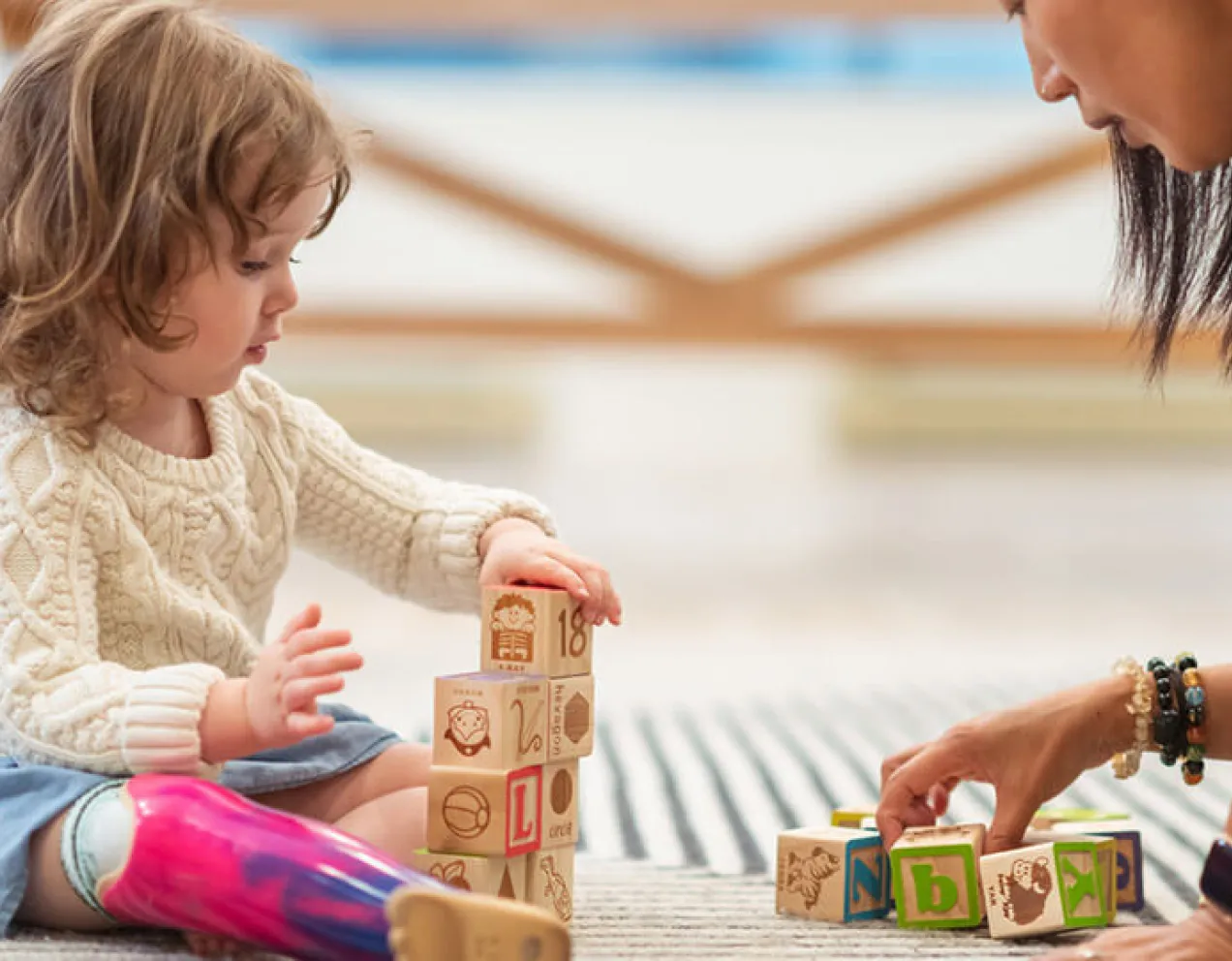 Occupational therapy assistant working with girl toddler