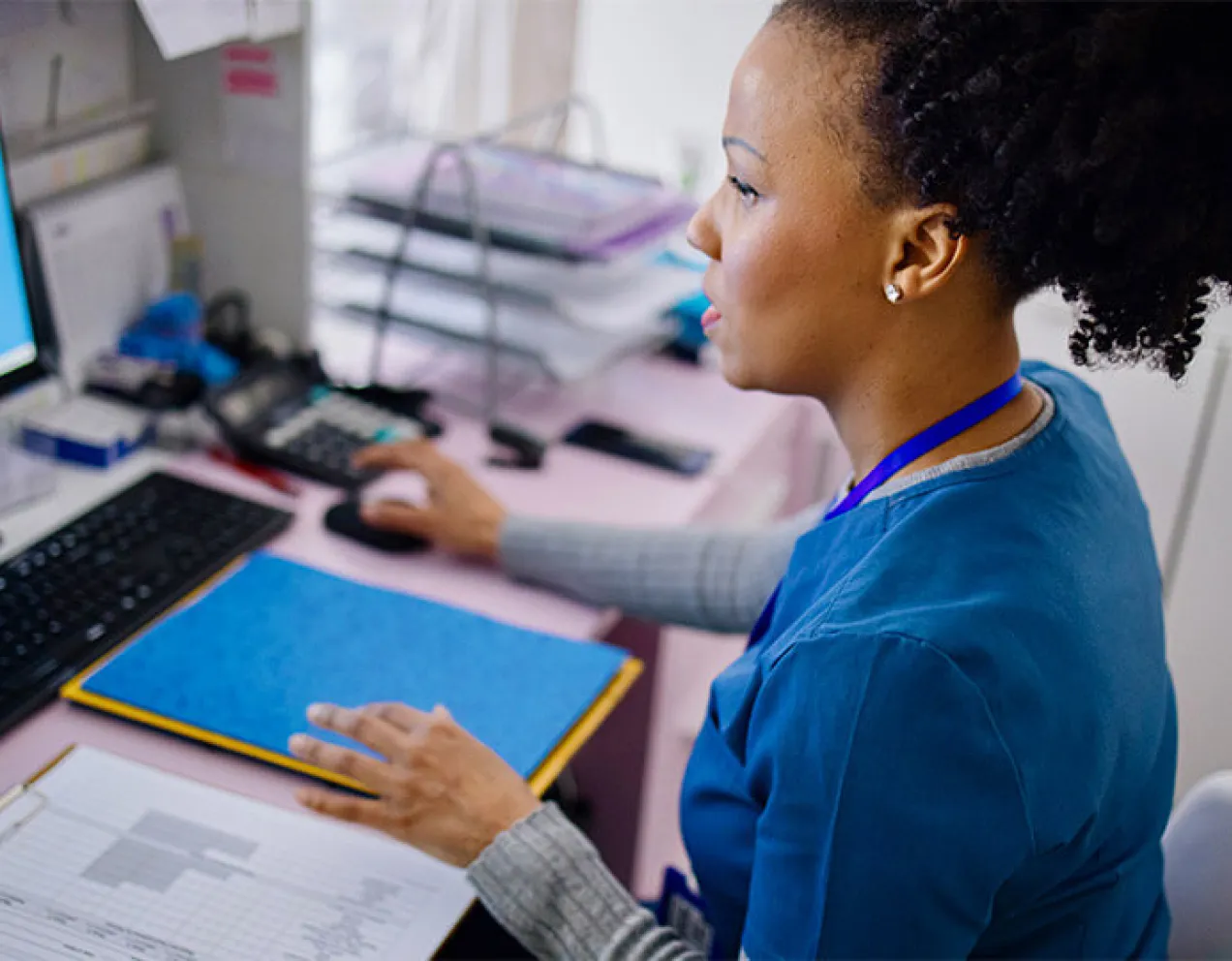 A medical assistant works to file medical records
