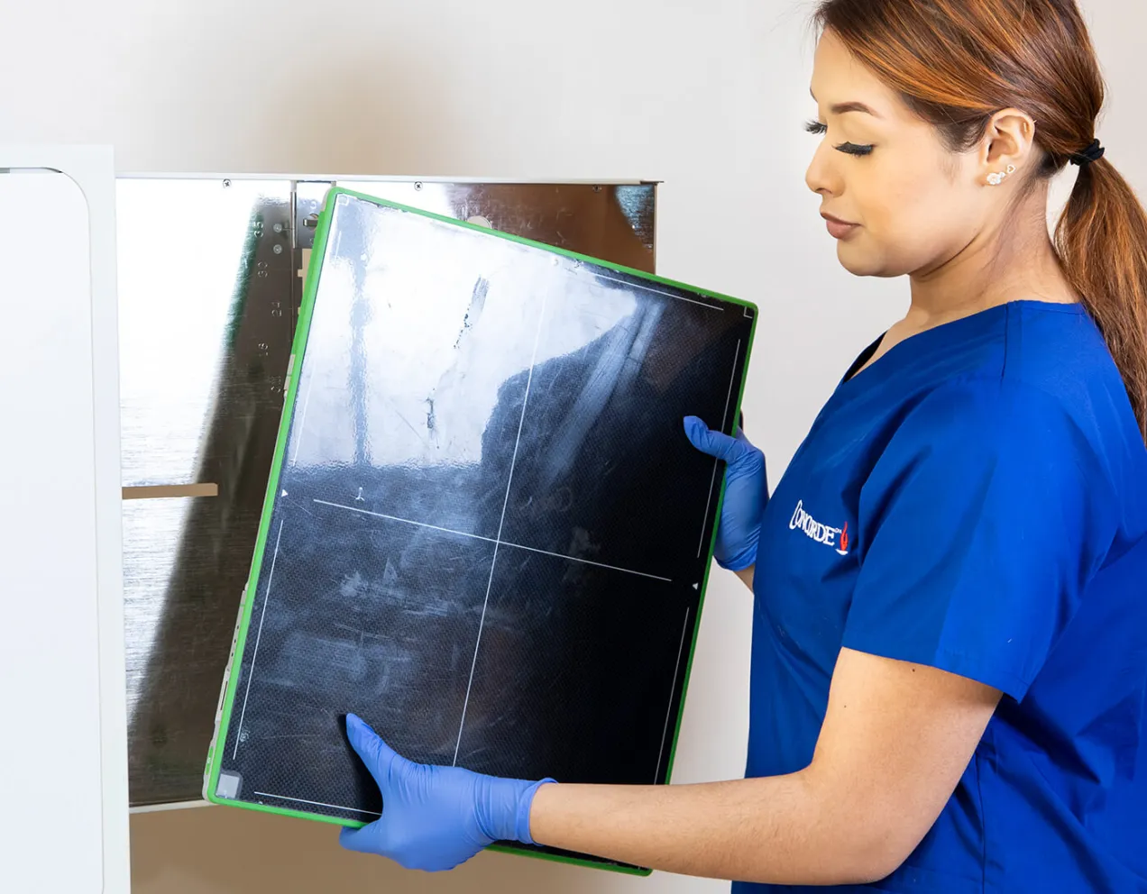 Technology skills being demonstrated by radiology tech holding x-ray film