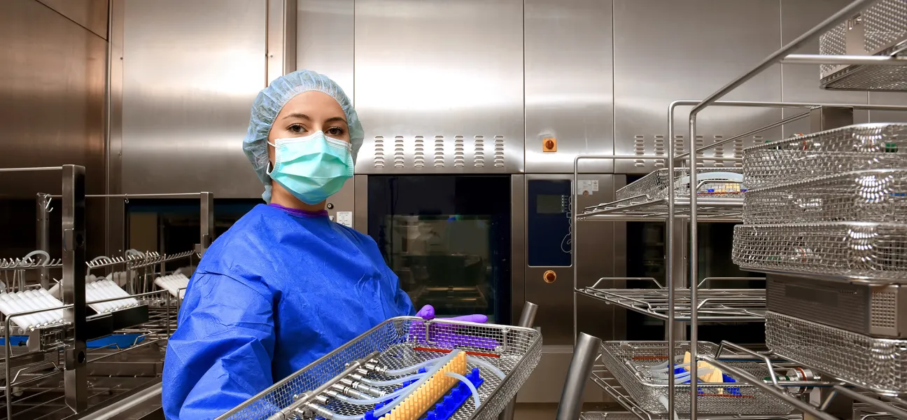 Sterile processing tech preparing instruments