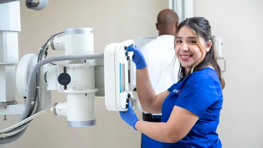 Radiologic Tech demonstrating skills at x-ray machine.