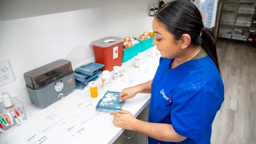 Pharmacy technician organizing medication during certification process.