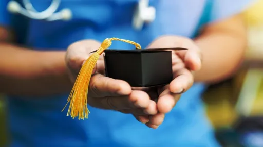 Nursing student holding graduation cap, symbolizing RN to BSN program completion and earning a Bachelor of Science in Nursing.
