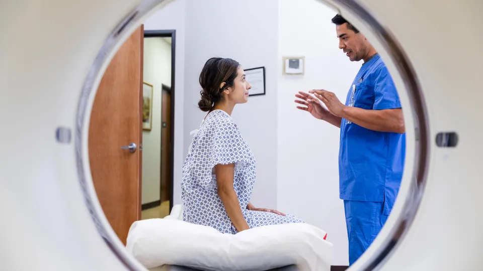 Radiology tech explains patient procedure.