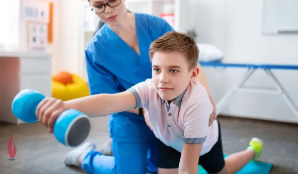 Occupational therapy assistant working with boy