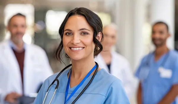 An LVN stands in front of her fellow medical teammates