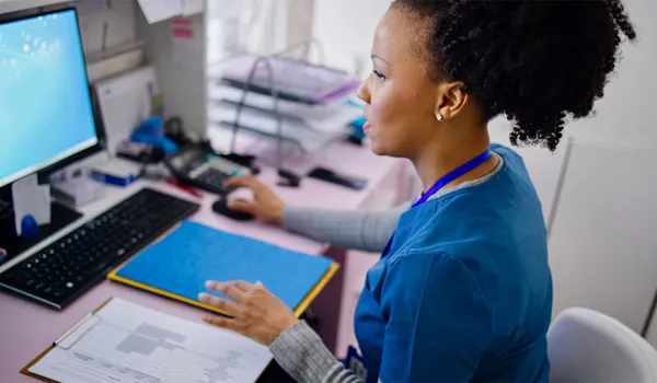 A medical assistant works to file medical records