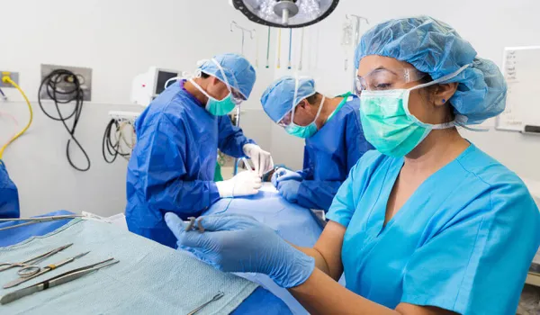 surgical tech retrieving a tool for a surgeon