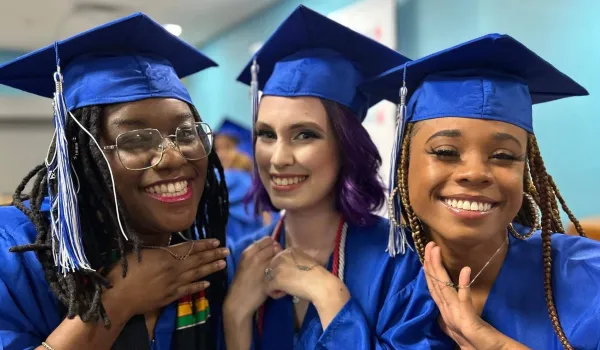 Amy Marks with two Concorde Alum friends at graduation ceremony