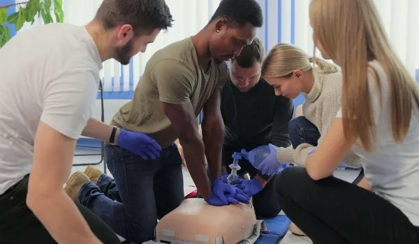 A group of students practices prerequisite CPR training.