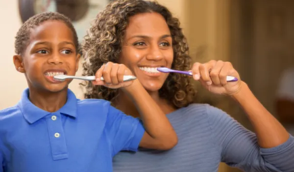 Mom and child brushing teeth