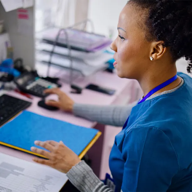 A medical assistant works to file medical records