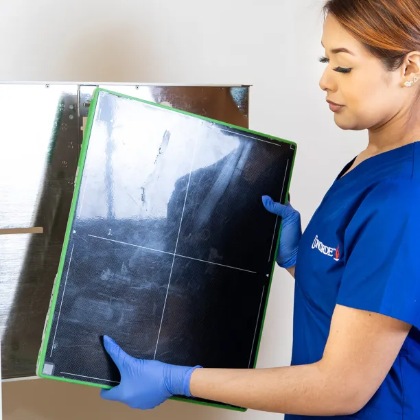 Technology skills being demonstrated by radiology tech holding x-ray film