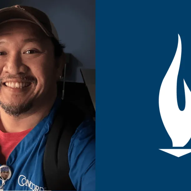 Arnold Septimo wearing blue Concorde scrubs and smiling for the camera