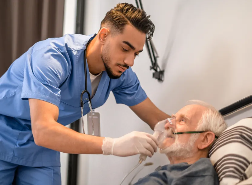 Respiratory Therapist helping patient with breathing treatment.