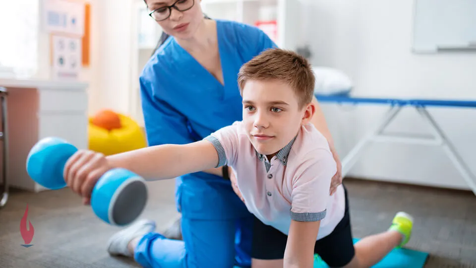 Occupational therapy assistant working with boy