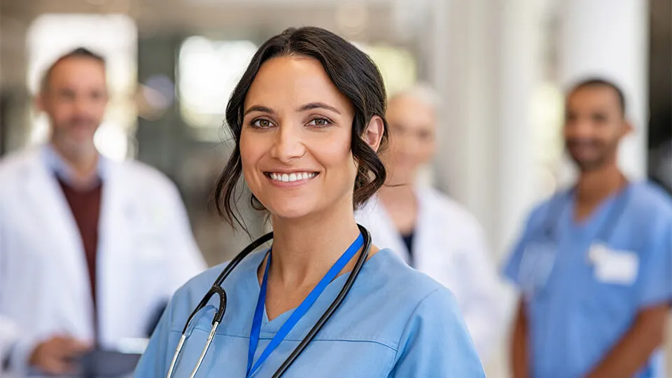 LVN standing with collegues An LVN stands in front of her fellow medical teammates