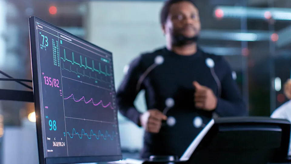 Treadmill cardio tests capture vital signs. Treadmill cardio tests capturing vitals of man running.