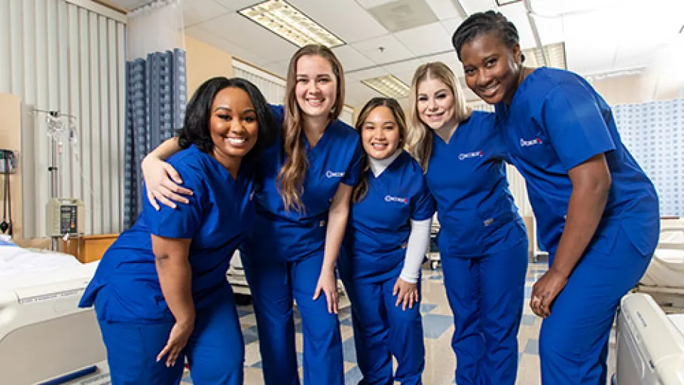 5 smiling LPN graduates from Concorde wearing their scrubs. 5 smiling LPN graduates from Concorde wearing their scrubs.