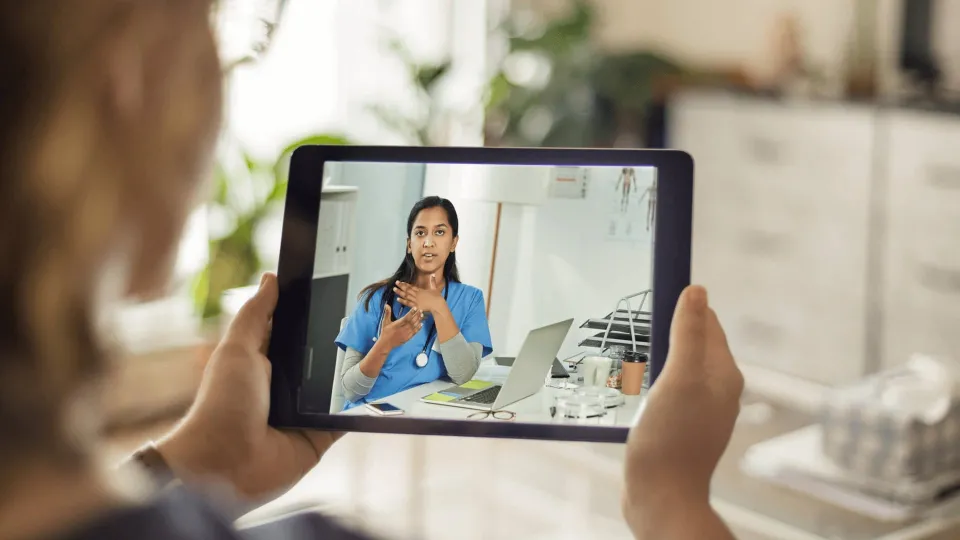 Telehealth service being offered by healthcare professional on tablet