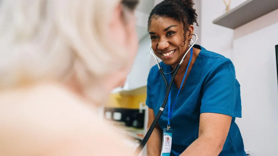 Nurse using a stethoscope during a patient assessment, showcasing clinical responsibilities in nursing. Nurse using a stethoscope during a patient assessment, showcasing clinical responsibilities in nursing.