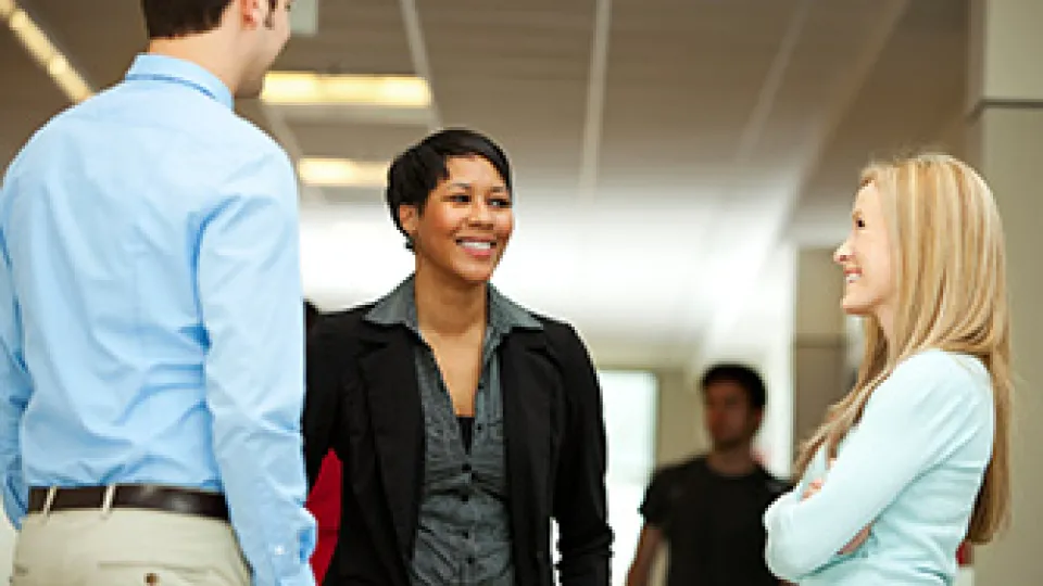 Professionals standing and talking.
