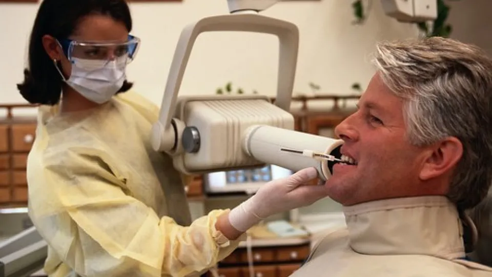 DA vs DH Dental Hygienist taking an x-ray