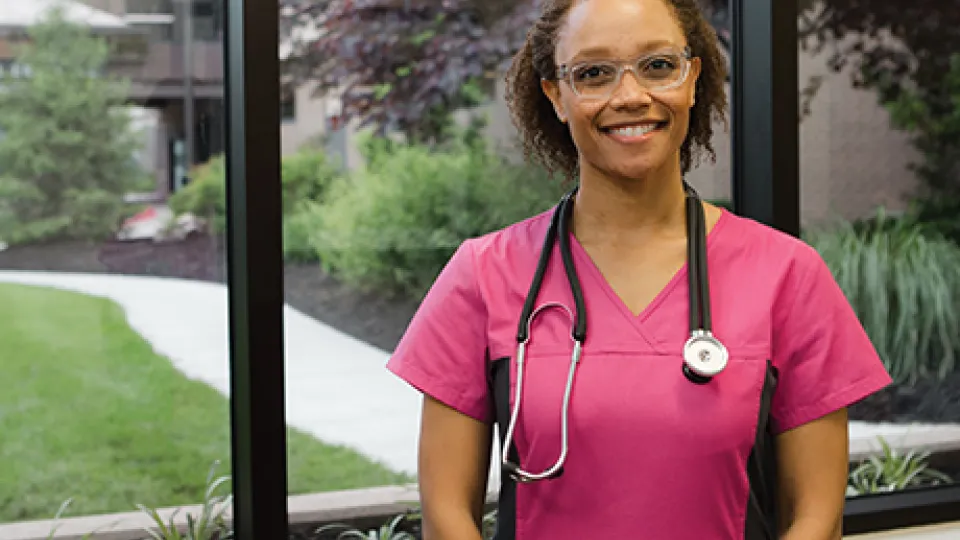 MA Medical Assistant holding a medical chart