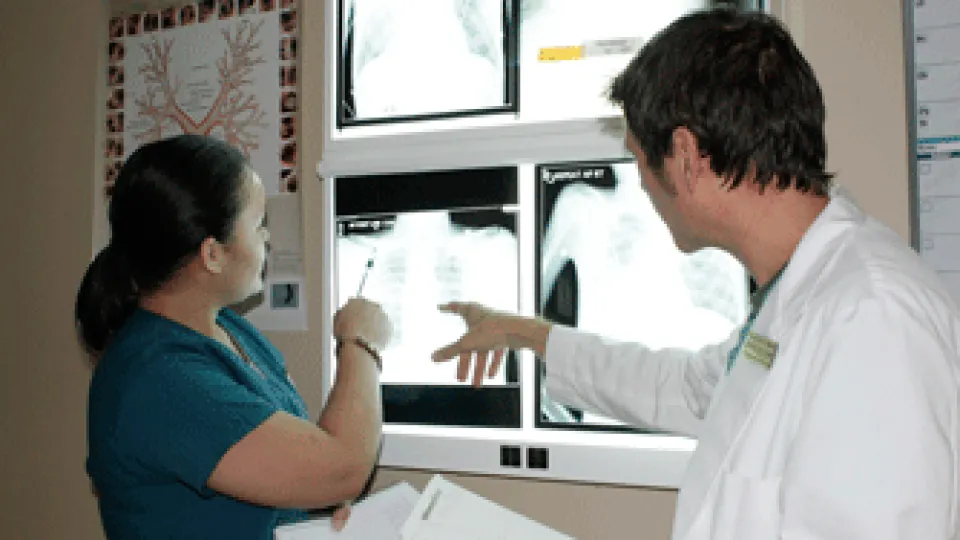 Student and Instructors looking at an x-ray. Student and Instructors looking at an x-ray.