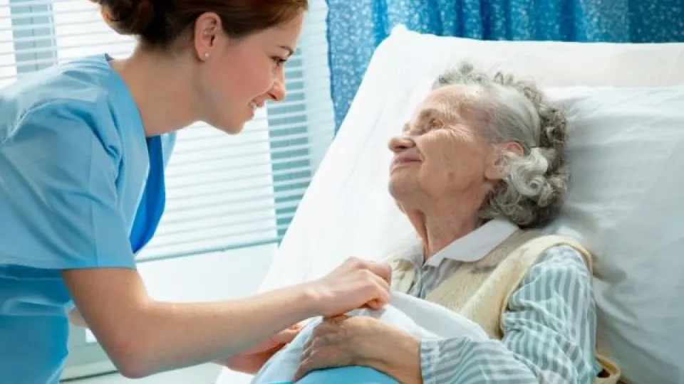 Practical Nurse cares for patient in bed Practical Nurse cares for patient in bed