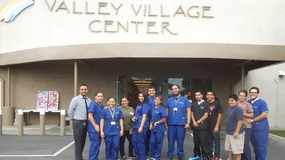 Concorde students standing outside Valley Village Center where they volunteer their time Concorde students standing outside Valley Village Center where they volunteer their time
