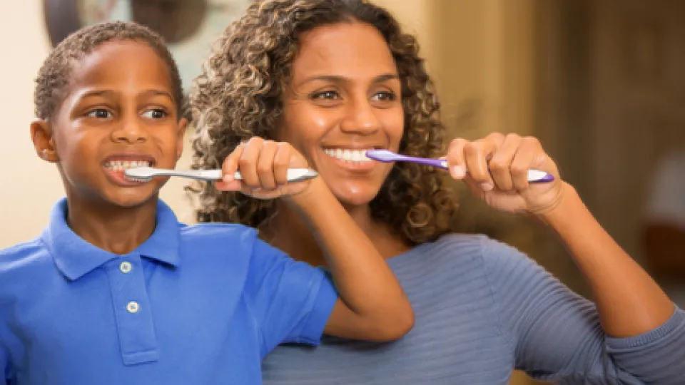 Mom and child brushing teeth Mom and child brushing teeth
