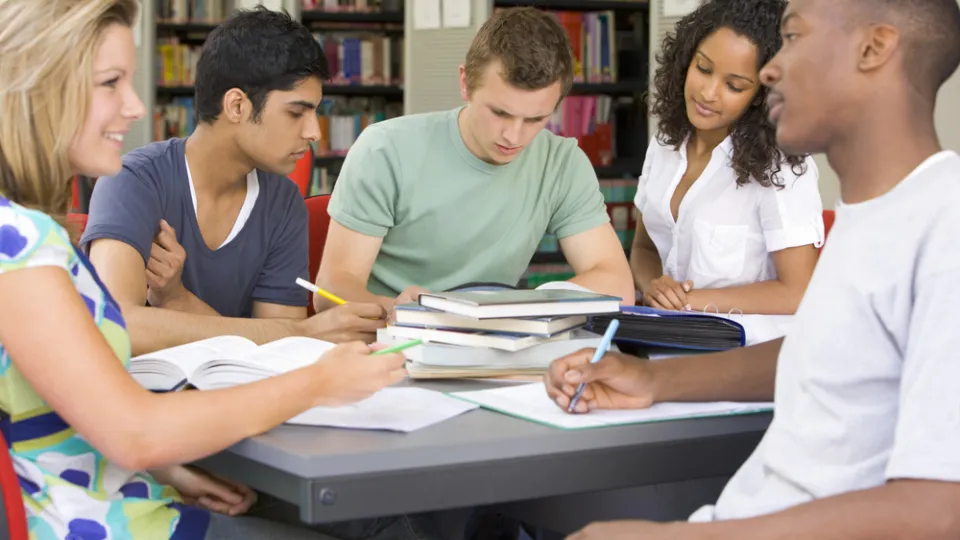 College students studying together in a library health care studies