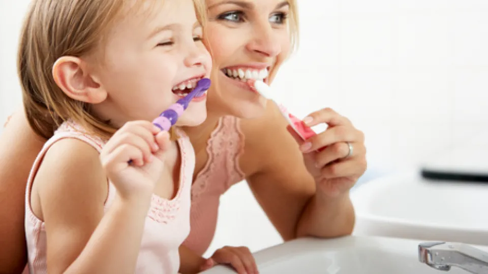 Mom and child brushing teeth Mom and child brushing teeth