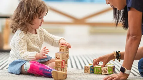 Occupational therapy assistant working with toddler