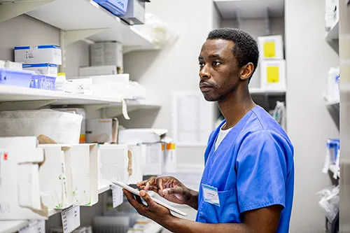 Pharmacy tech counting inventory on tablet