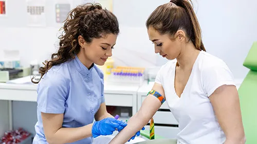 Medical professional draws blood from patient to evaluate heart health.