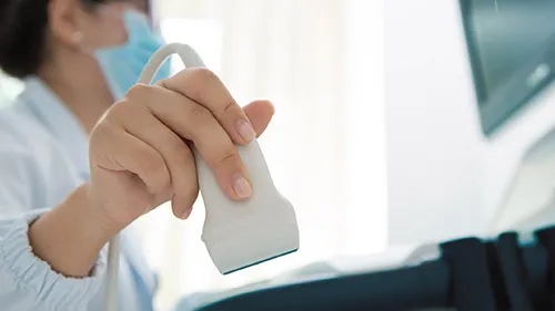 Sonographer holding an array wand