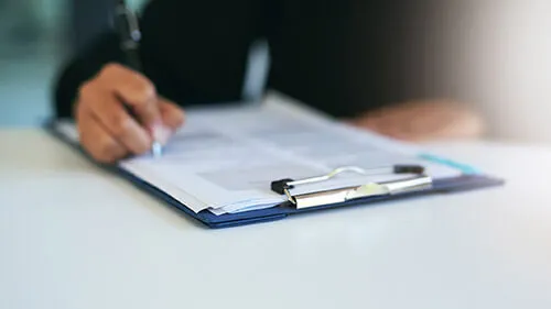 A patient fills out a depression screening questionnaire at the doctor's office as they wait to see the physician.