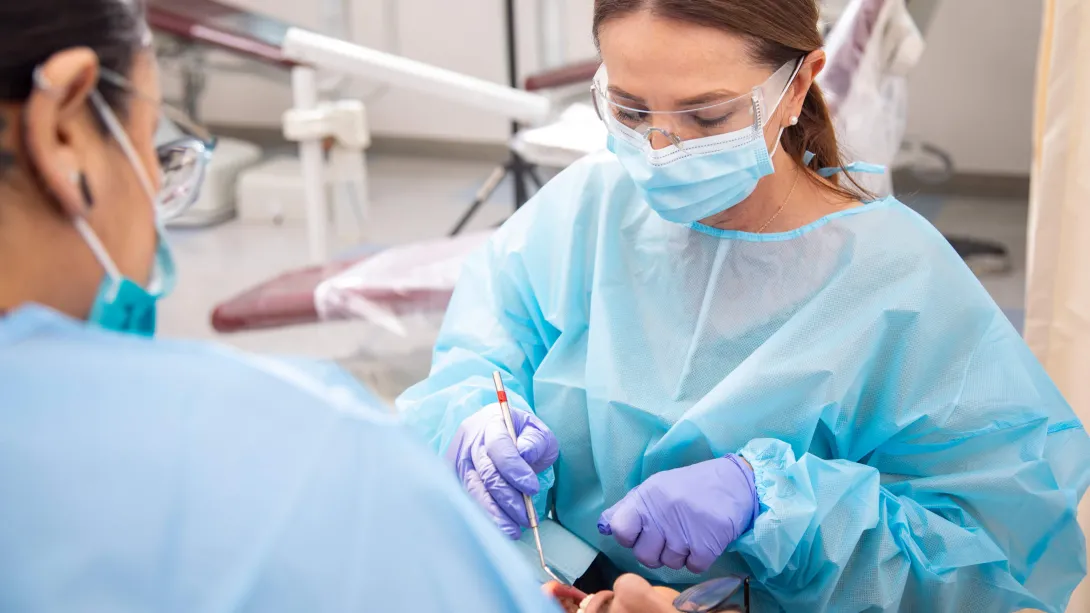 Dental Assistant assists dentist during dental procedure.