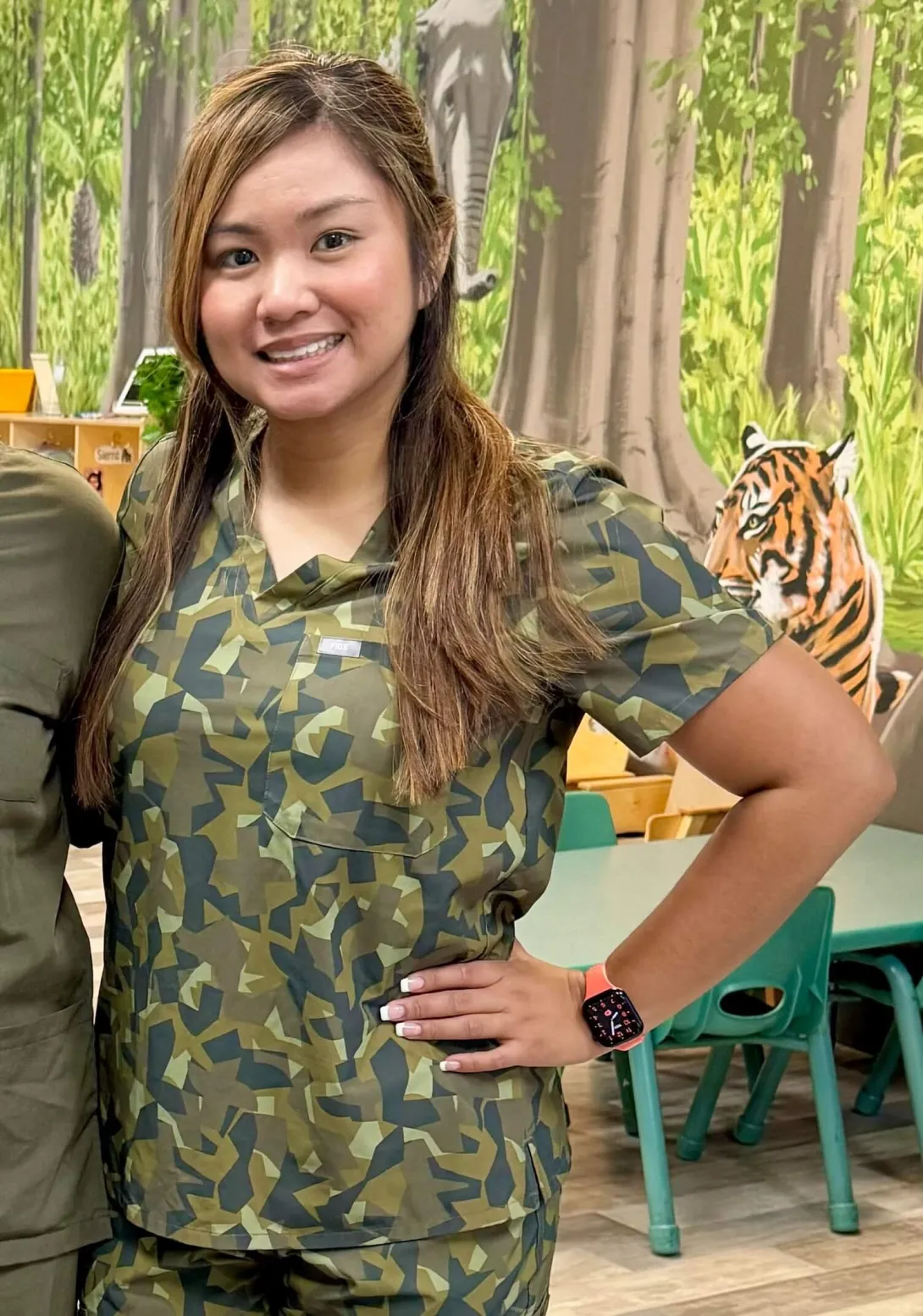Sarah Duron in camouflage scrubs at work