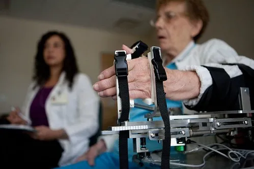 Occupational Therapist helping patient with hand